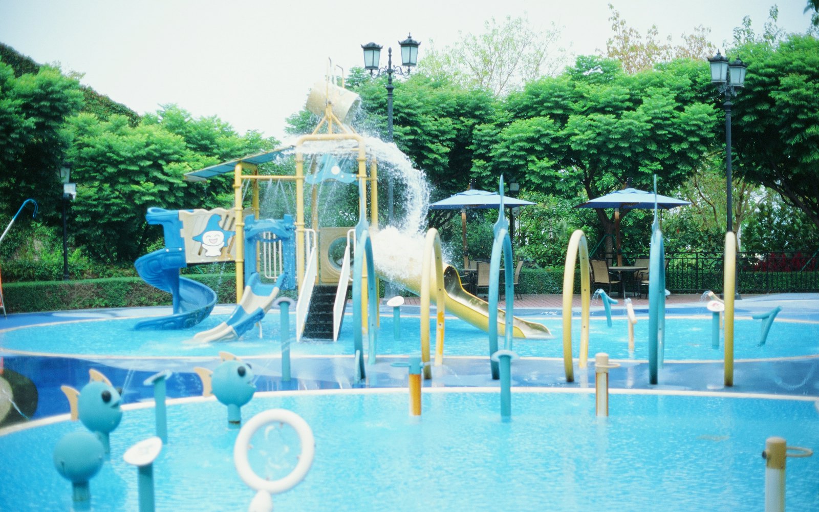 Colorful water play structures and spraying jets at Lakeside Splash Park.