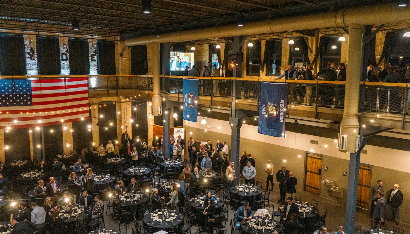 People gathered for an event inside a large community hall.