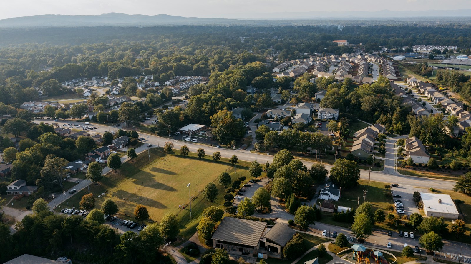 An aerial view of tree-lined neighborhoods and open green space within the district.